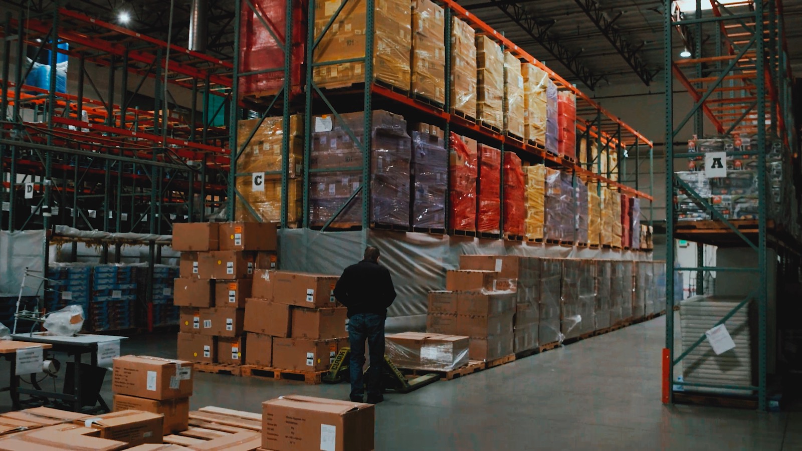 Recovered inventory racked and staged on pallets inside a QCI warehouse