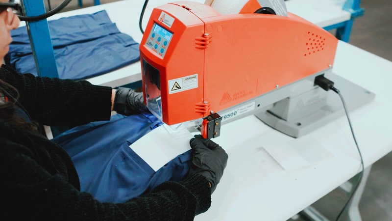QCI technician applying corrected product labels at a tagging station